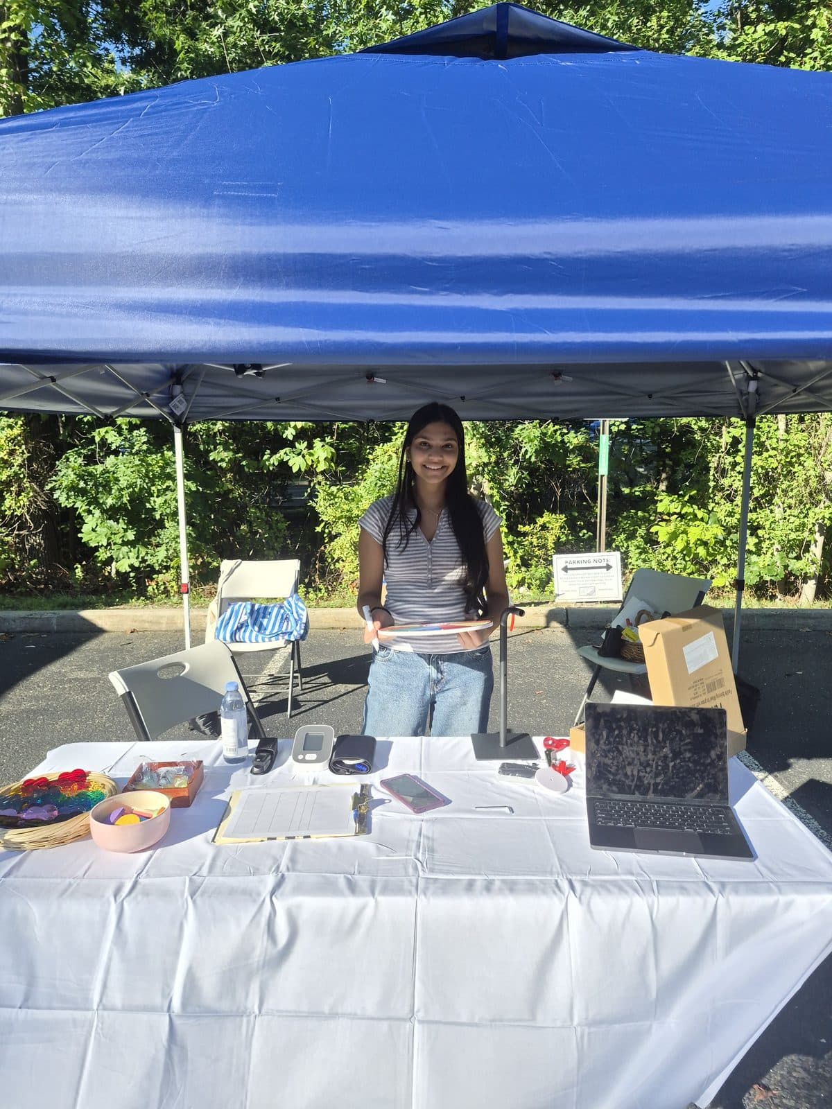 The MoniVitals screening table set up under a blue tent
